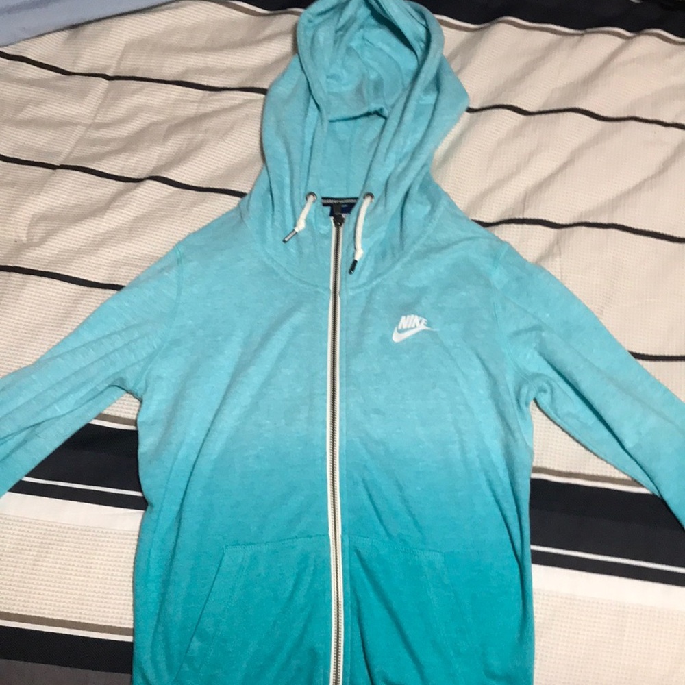 This is a turquoise Nike zip up.